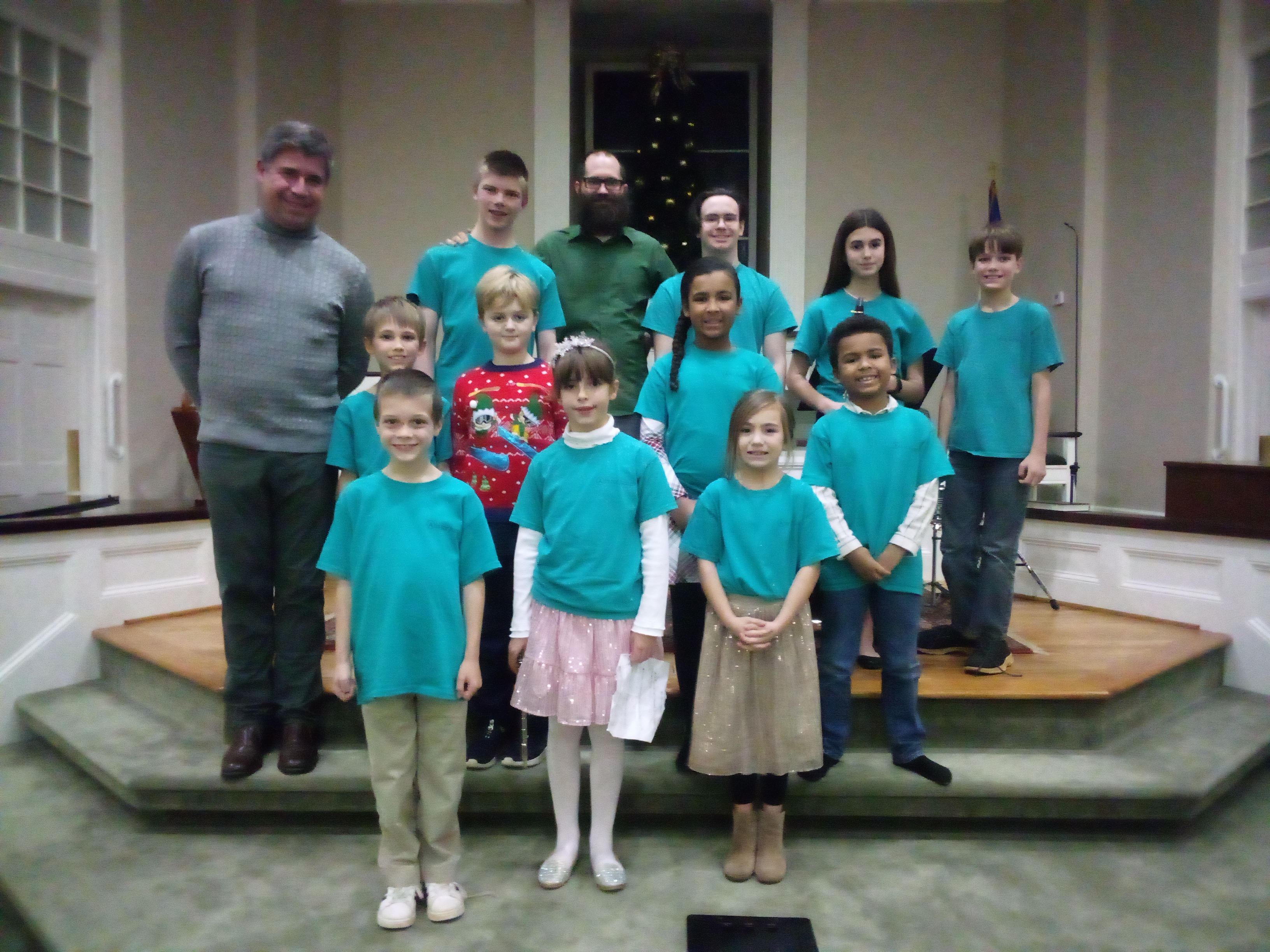 David Justin Freeman, headmaster at the School of Future Arts in Clarkesville Georgia, poses with students after a Christmas recital held at Clarkesville First Baptist Church